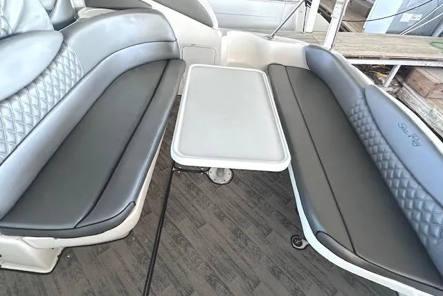 Slide: The Image of 2001 Sea Ray 340 Sundancer interior seating with table, featuring gray upholstery. - 7