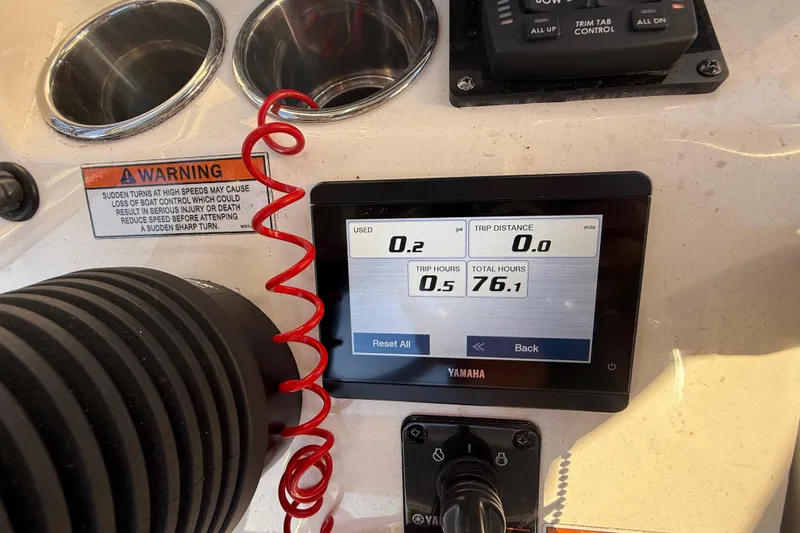 Slide: The Image of Dashboard of 2022 Pathfinder 2005 TRS boat with Yamaha display and warning label. - 104
