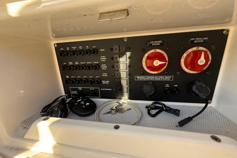 Slide: The Image of Control panel of a 2022 Pathfinder 2005 TRS boat with switches and keys. - 105