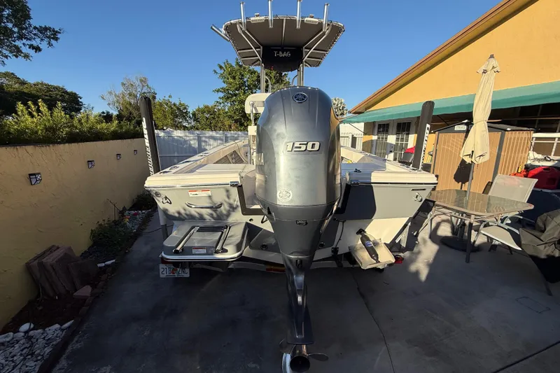 Slide: The Image of Pathfinder 2005 TRS boat with Yamaha 150 engine, parked in a driveway, 2022 model. - 20