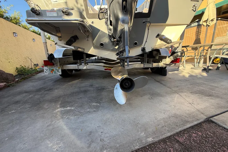 Slide: The Image of Rear view of a 2022 Pathfinder 2005 TRS boat on a trailer in a driveway. - 21