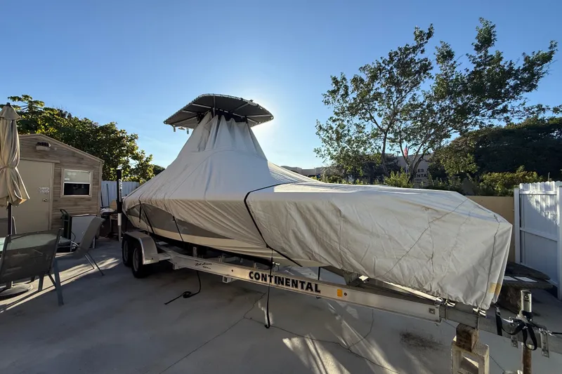 Slide: The Image of Covered 2005 Pathfinder TRS boat on trailer in sunny backyard setting. - 22