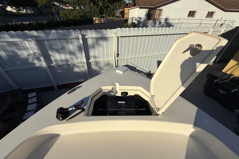 Slide: The Image of Open hatch on 2022 Pathfinder 2005 TRS boat, parked near white fence. - 26