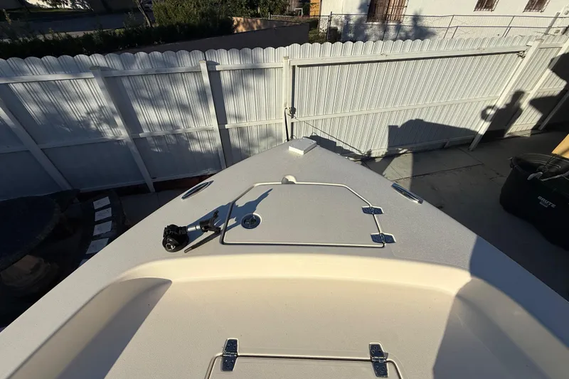 Slide: The Image of Bow of 2022 Pathfinder 2005 TRS boat in a fenced yard. - 27