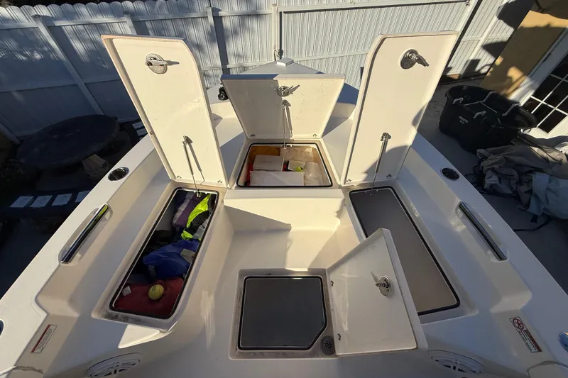 Slide: The Image of Open storage compartments on a 2022 Pathfinder 2005 TRS boat deck. - 34