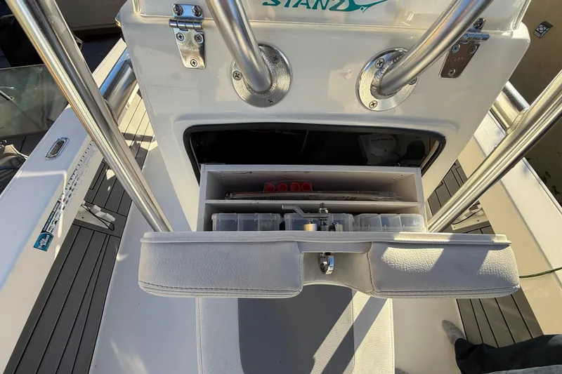 Slide: The Image of 2005 Pathfinder TRS boat console with open storage compartment, showcasing organized fishing gear. - 35