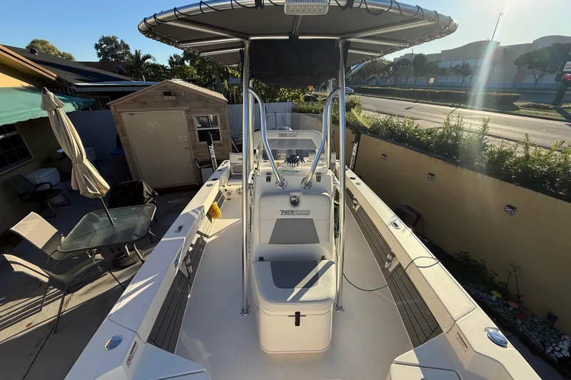 Slide: The Image of 2005 Pathfinder TRS boat with canopy, parked outdoors, sunlight casting shadows. - 37