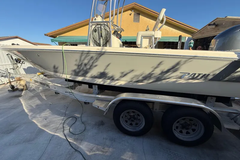 Slide: The Image of Pathfinder 2005 TRS boat on trailer, parked in driveway, sunny day. - 4