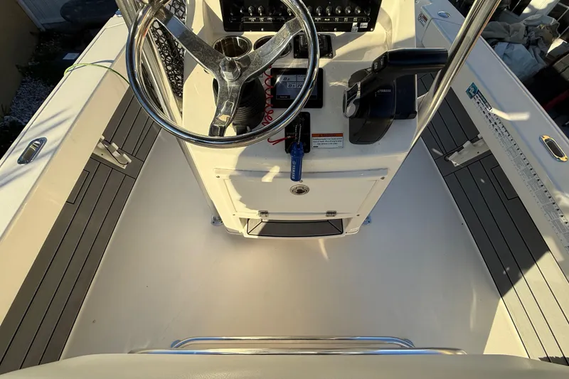Slide: The Image of Center console of a 2022 Pathfinder 2005 TRS boat with steering wheel and controls. - 42