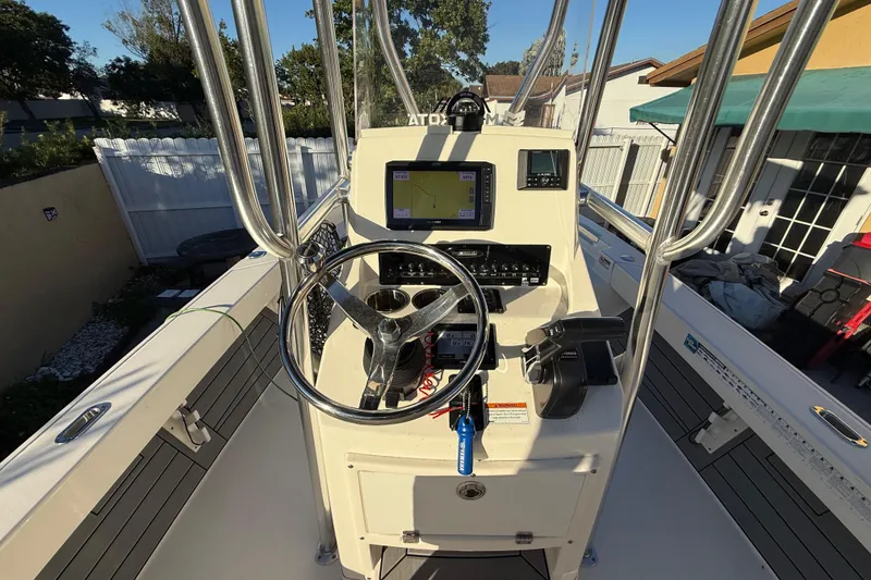 Slide: The Image of Center console of a 2022 Pathfinder 2005 TRS boat with steering wheel and navigation equipment. - 43