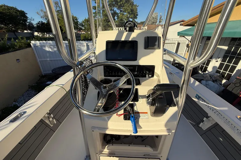 Slide: The Image of Center console of a 2022 Pathfinder 2005 TRS boat with steering wheel and controls. - 44