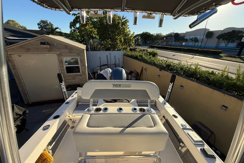 Slide: The Image of Pathfinder 2005 TRS boat in driveway, surrounded by greenery and a small shed. - 45