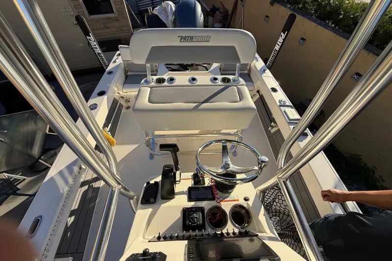 Slide: The Image of Interior view of a 2022 Pathfinder 2005 TRS boat, featuring steering and seating area. - 46