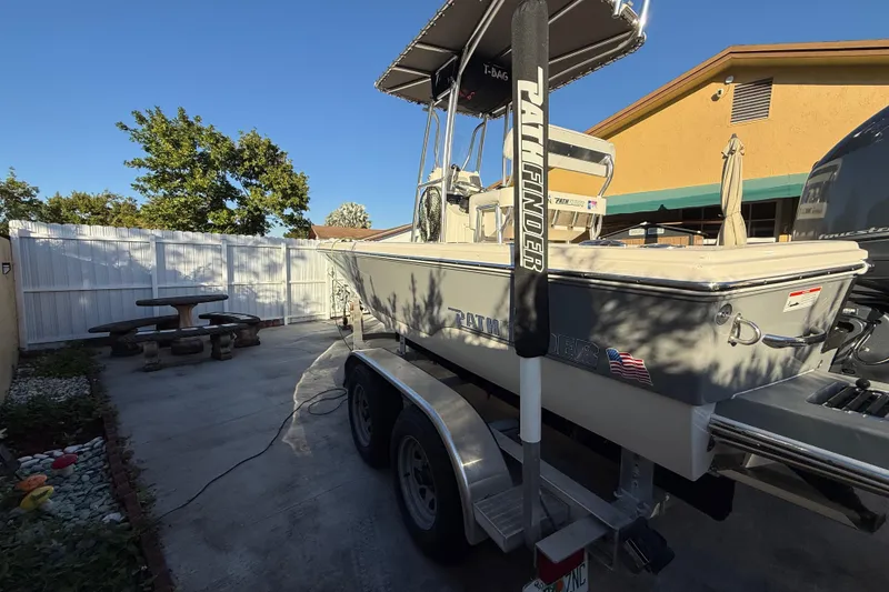Slide: The Image of Pathfinder 2005 TRS boat on trailer in sunny backyard, 2022 model. - 5