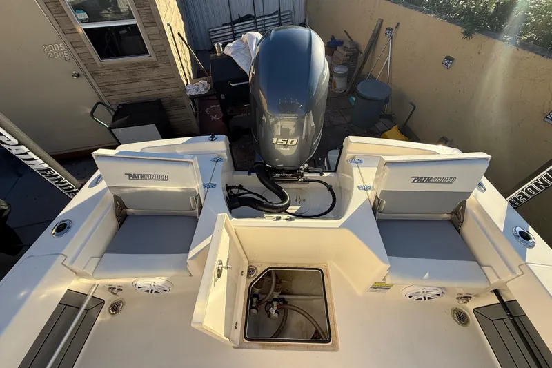 Slide: The Image of 2005 Pathfinder TRS boat with Yamaha 150 engine, open storage compartments, and seating. - 52