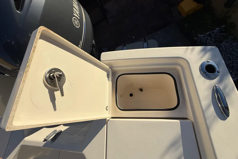 Slide: The Image of Open storage compartment on 2022 Pathfinder 2005 TRS boat, with Yamaha engine visible. - 55