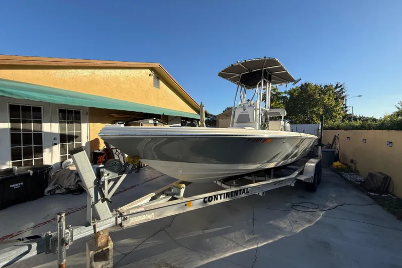 Slide: The Image of Pathfinder 2005 TRS boat on trailer in driveway, sunny day, 2022 model. - 6