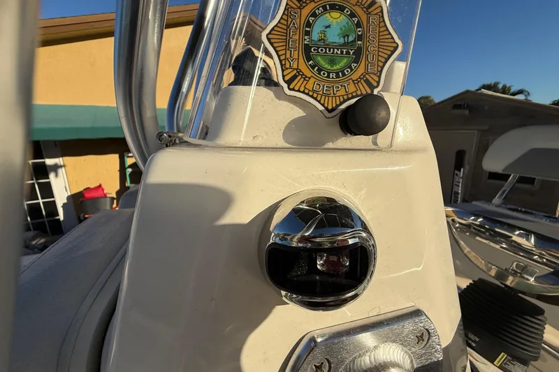 Slide: The Image of 2005 Pathfinder TRS boat console with Miami-Dade County safety badge, photographed in 2022. - 61