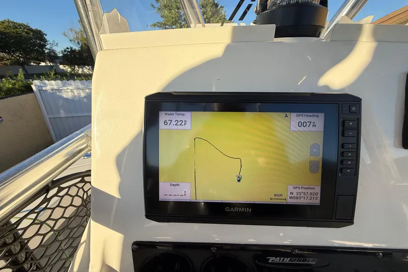 Slide: The Image of Boat dashboard with Garmin GPS, showing water temperature and navigation path. Pathfinder 2005 TRS model. - 86