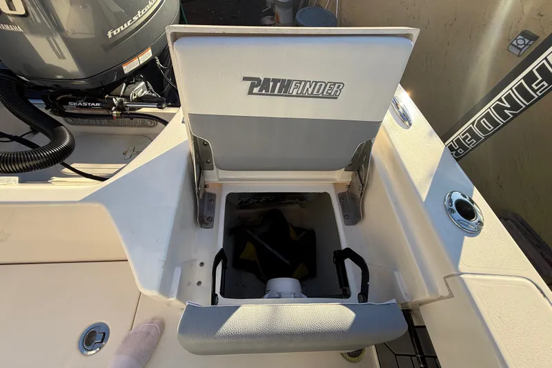 Slide: The Image of 2005 Pathfinder TRS boat seat with storage compartment, featuring Seastar four-stroke engine. - 93
