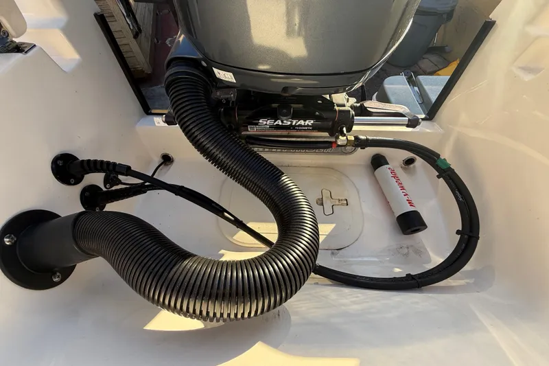 Slide: The Image of Boat engine compartment of 2005 Pathfinder TRS, featuring SeaStar hydraulic steering system. - 96