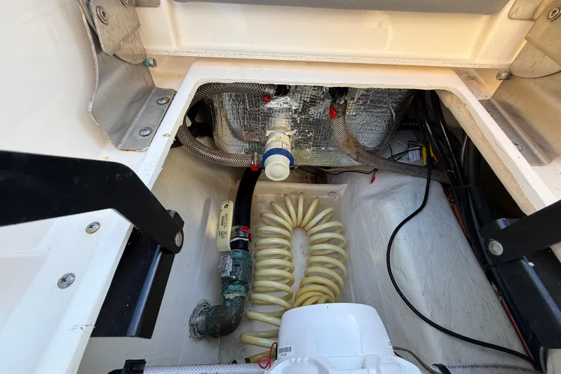 Slide: The Image of Pathfinder 2005 TRS 2022 model boat interior showing wiring and plumbing components. - 99