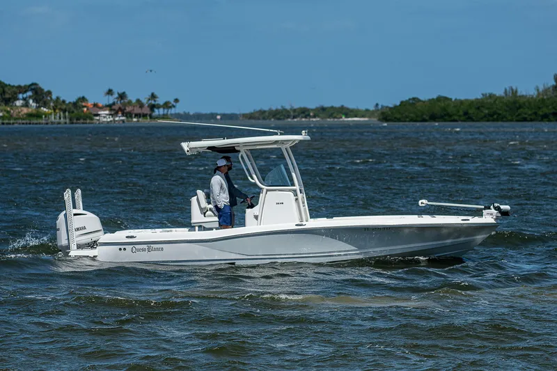 Slide: The Image of 2021 Caymas 26 HB boat cruising on a sunny day with a person at the helm. - 10