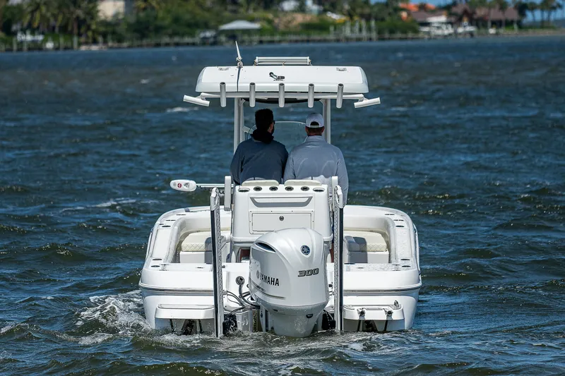 Slide: The Image of 2021 Caymas 26 HB boat with Yamaha 300 engine cruising on open water. - 13