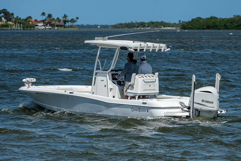 Slide: The Image of 2021 Caymas 26 HB boat cruising on a sunny day with two passengers. - 14