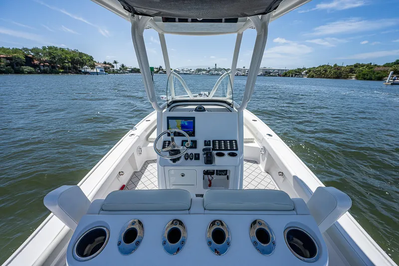 Slide: The Image of 2021 Caymas 26 HB boat interior with steering console on open water. - 25
