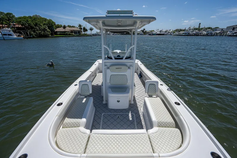 Slide: The Image of 2021 Caymas 26 HB boat on calm water, featuring spacious seating and sleek design. - 28
