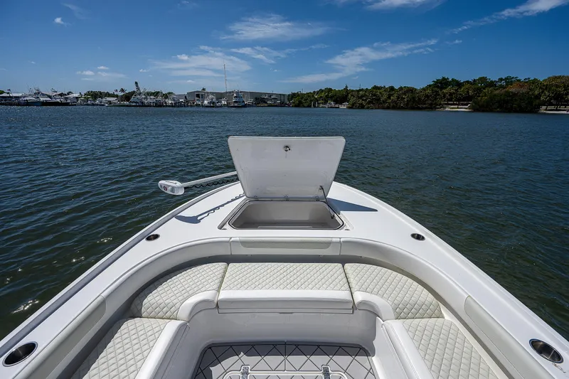 Slide: The Image of 2021 Caymas 26 HB boat with open storage, on calm water under blue sky. - 29