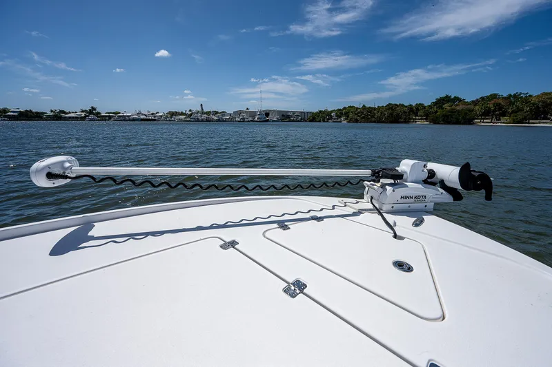 Slide: The Image of 2021 Caymas 26 HB boat with Minn Kota trolling motor on calm water. - 31