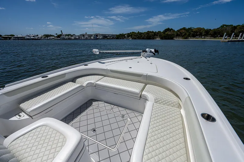 Slide: The Image of 2021 Caymas 26 HB boat with cushioned seating on calm water. - 33