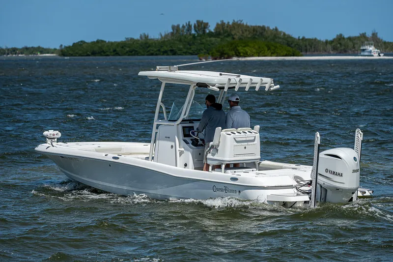 Slide: The Image of 2021 Caymas 26 HB boat cruising on open water with Yamaha engine. - 5