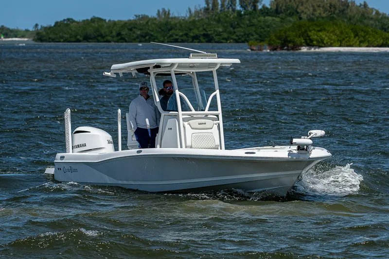 Slide: The Image of 2021 Caymas 26 HB boat cruising on water with two passengers, featuring Yamaha engine. - 8