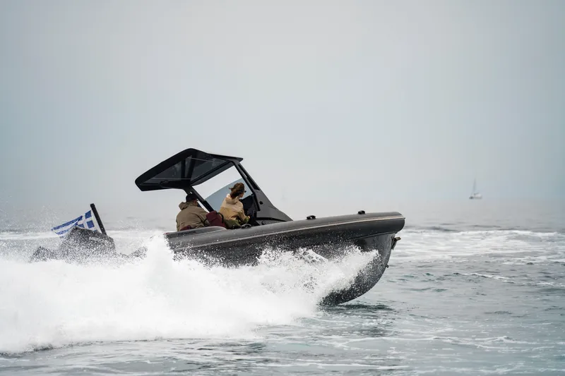 Slide: The Image of 2026 Rock Marine RM 30 boat navigating waves, featuring a Greek flag. - 8