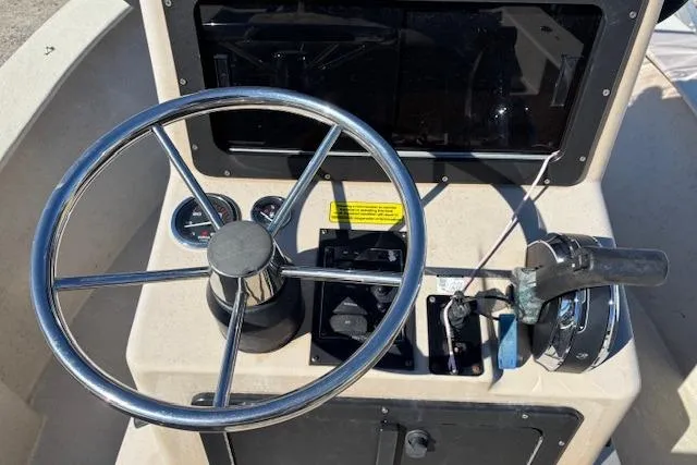 Slide: The Image of 2022 May-Craft 1800 Center Console boat dashboard with steering wheel and controls. - 17