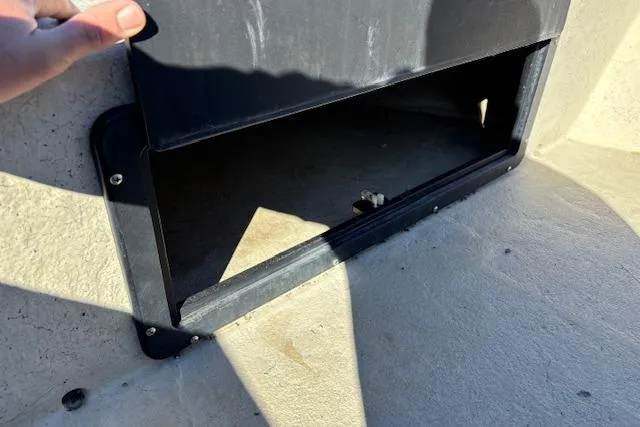 Slide: The Image of Open storage compartment on a 2022 May-Craft 1800 Center Console boat. - 22