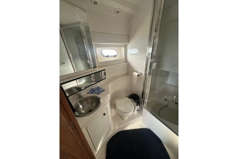Slide: The Image of Bathroom interior of 1997 Bayliner 3988 Command Bridge Motoryacht, featuring sink, toilet, and shower. - 51