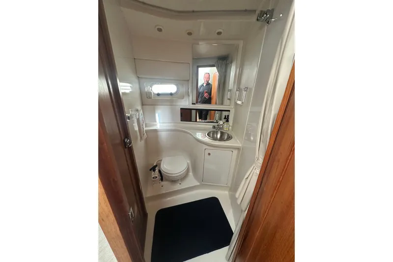 Slide: The Image of Bathroom interior of 1997 Bayliner 3988 Command Bridge Motoryacht, featuring sink and toilet. - 52