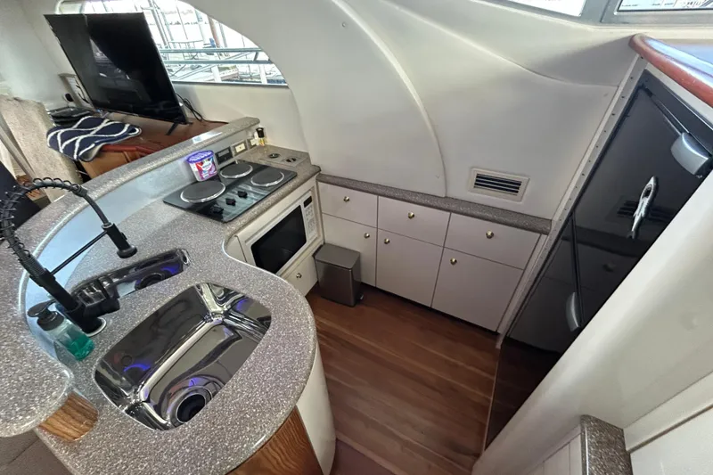 Slide: The Image of 1999 Maxum 4600 SCB yacht kitchen with modern appliances and sleek countertops. - 10