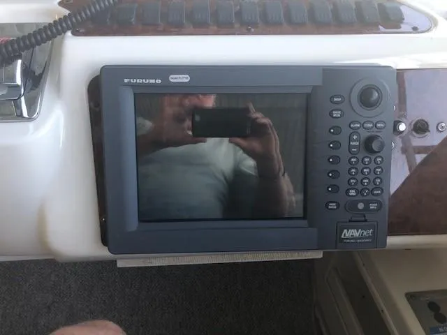 Slide: The Image of 1999 Maxum 4600 SCB yacht helm with navigation equipment and wooden steering wheel. - 13