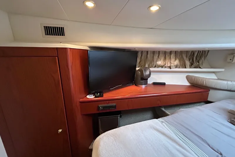 Slide: The Image of 1999 Maxum 4600 SCB yacht interior with curved seating, table, and decorative accents. - 23