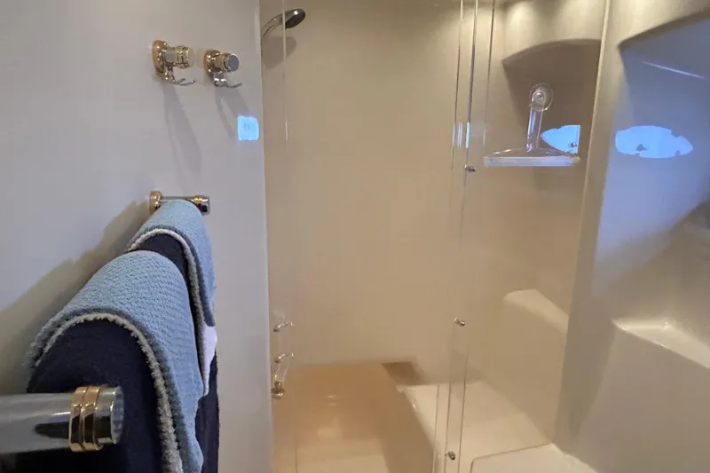 Slide: The Image of 1999 Maxum 4600 SCB yacht interior with wooden steps and seating area. - 25