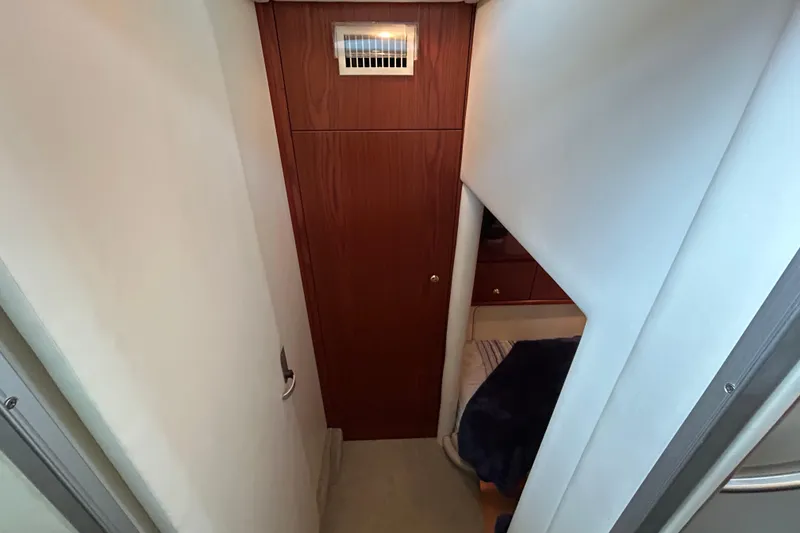 Slide: The Image of 1999 Maxum 4600 SCB yacht helm with steering wheel, navigation equipment, and seating. - 27