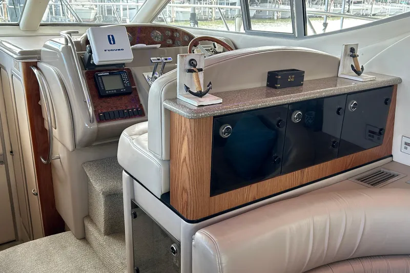 Slide: The Image of 1999 Maxum 4600 SCB yacht interior with white seating and wooden flooring. - 30