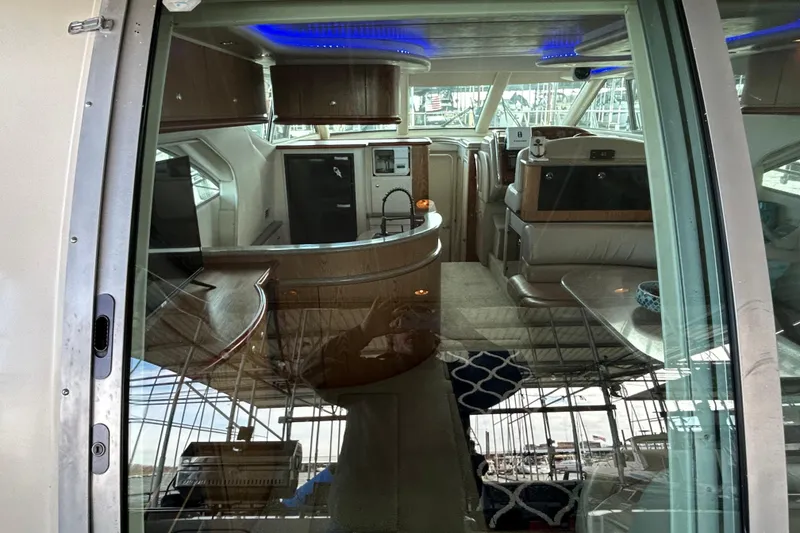 Slide: The Image of 1999 Maxum 4600 SCB yacht interior with seating and wooden deck. - 32