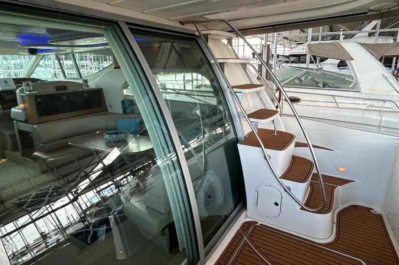 Slide: The Image of 1999 Maxum 4600 SCB yacht docked in a marina, showcasing sleek design and spacious deck. - 33