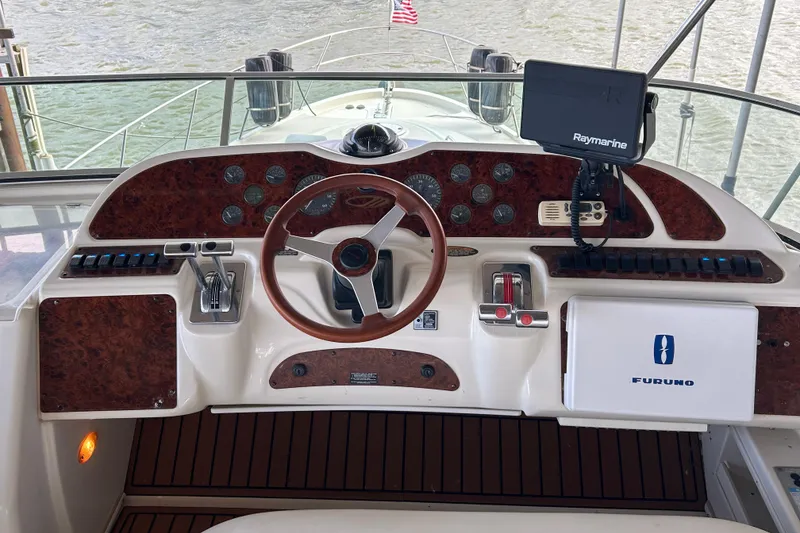 Slide: The Image of 1999 Maxum 4600 SCB yacht docked in a marina, front view. - 36